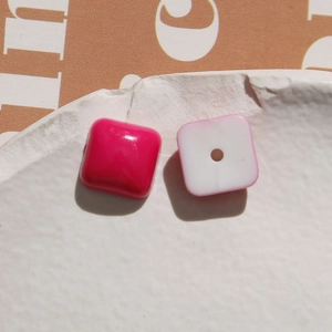 Macro shot of macaron colored square resin beads with center holes for DIY jewelry