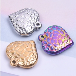 Detailed macro view of heart-shaped pendants with unique pebble-textured metal finish