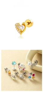 Macro shot of assorted stainless steel stud earrings with zircons and floral motifs