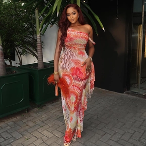 One-shoulder printed maxi dress in orange and yellow floral patterns for vacation style