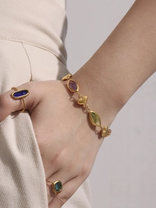 Detail of 18k gold plated bracelet with colorful Czech glass and heart-shaped charms