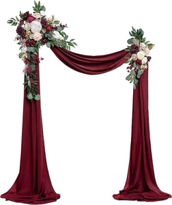 Detail of burgundy artificial roses and chiffon drape set for wedding arch decor
