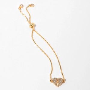 Detail of adjustable gold-plated heart bracelet with zircon pave setting and box chain