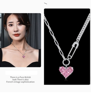 Macro detail of pink heart pendant necklace with asymmetrical chain and paperclip link