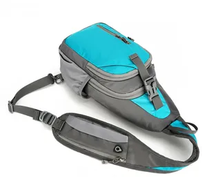 Flat lay of blue and grey waterproof chest bag with multiple pockets and wide strap