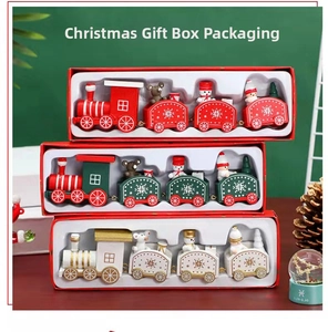 Close-up of wooden Christmas train set gift boxes in red, green, and ivory white colors