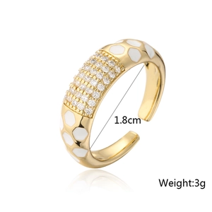 Detailed view of an 18K gold-plated open ring with white enamel and micro-pave crystals