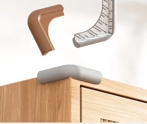 Detailed view of L-shaped silicone baby safety corner guards with adhesive tape backing