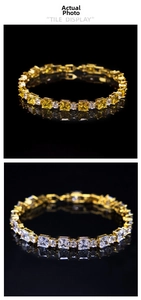 Detail view of gold tennis bracelets with square yellow and clear zircon in claw setting