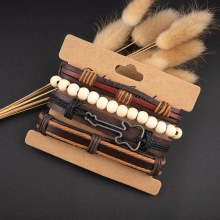 Detail view of multilayer vintage leather bracelets with wood beads and guitar charm pendant