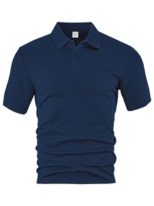 Close-up of navy blue polo shirt featuring textured diamond jacquard knit fabric detail