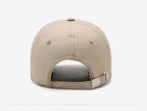 Detail of khaki quick-dry baseball cap featuring laser-cut vents and metal buckle closure