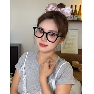 Close-up of stylish black thick frame glasses for women for face shaping on model