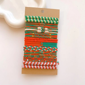 Detail of Christmas themed elastic hair ties set with festive red green and white braids