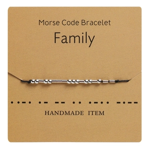 Handmade Morse Code Family bracelet on kraft card with black rope and silver beads