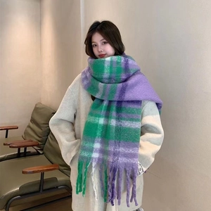 Detail of purple and green plaid mohair scarf with soft fringe and small textile tag