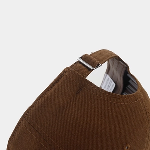 Close-up of cotton baseball cap back with adjustable fabric strap and metal buckle