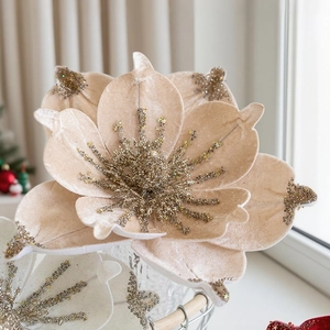 Macro detail of champagne velvet magnolia with golden glitter for Christmas tree decor