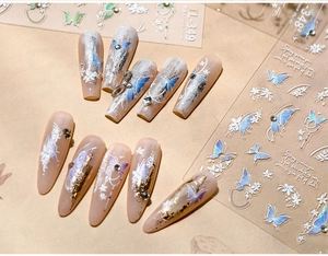 Close-up of TL-349 butterfly nail stickers with embossed textures and gradient nails