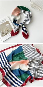 Detail of artistic geometric striped silk scarf with knot styling and smooth texture