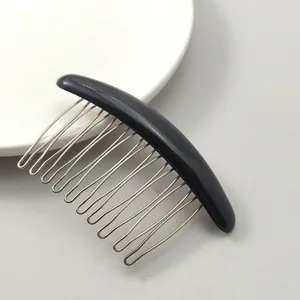 Detail of a 10-tooth metal hair comb with black resin top for securing loose hair