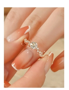 Macro view of rose gold engagement ring with wavy band and sparkling moissanite stone
