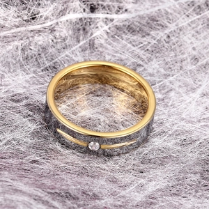 Detailed close-up of a two-tone tungsten ring with a centered sparkling round diamond