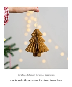 Detail of a mini Christmas tree paper pendant featuring accordion folding in kraft brown color