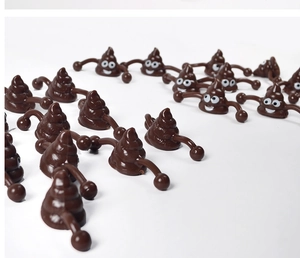 Multiple creative slingshot poop toys in dark brown finish on a white background