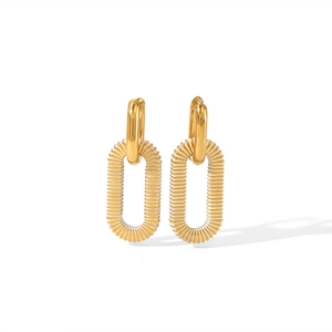 Macro shot of 18k gold earrings featuring a small round hoop and a rectangular striped link