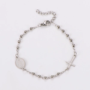 Detail of silver rosary bracelet with crucifix and Virgin Mary medal charms