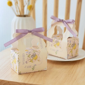 Pink floral paper gift box with purple ribbon and Best Wishes text for wedding candy