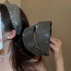 Detailed close-up showing full rhinestone embellishments on a wide silver headband accessory