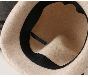Detail view of the beige wool bucket hat interior with sweatband and adjustable drawstring