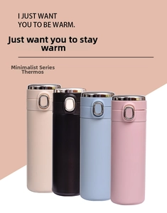 Four stainless steel insulated water bottles in beige black blue and pink colors