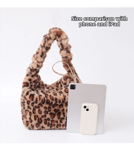 Leopard print plush crossbody bag shown next to a tablet and phone for size comparison