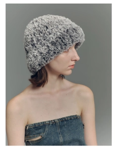 Close-up of gray and white faux fur texture on a warm winter knitted beanie for women