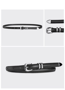 Detail of slim black leather belt featuring a silver metal buckle and refined stitching