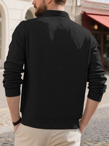 Detailed back view of men's black knit sweater featuring 3D geometric jacquard texture