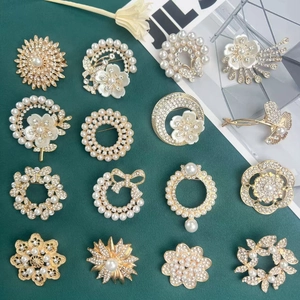 Elegant gold alloy brooches with white pearls and crystals in various vintage floral designs