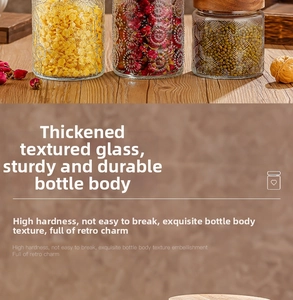 Macro view of embossed glass storage jars with bamboo lids for kitchen grains and tea