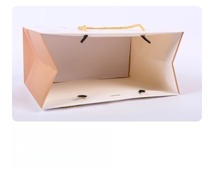 Detail of reinforced double-layer paper handles on a cartoon bear gift bag for durability