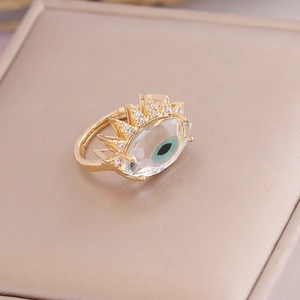 Macro shot of evil eye ring with green iris and inlaid zircons in a jewelry box
