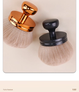 Detail of mushroom makeup brush with soft bristles and metallic handle for neck dusting