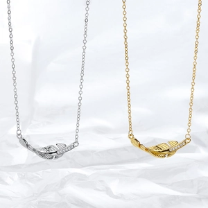 Elegant gold and silver feather pendant necklaces with sparkling rhinestones set on chains
