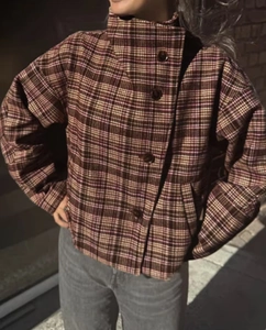 Detail of stand collar and brown plaid pattern on a cropped casual jacket