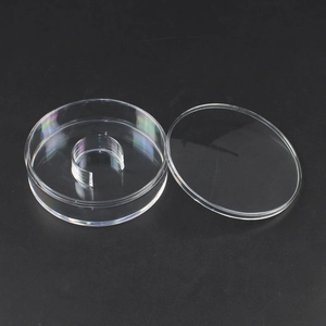 Clear round acrylic jewelry display box with internal ring stand on black background