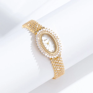 Detail of elegant gold oval watch with crystal bezel and luxury rhinestone studded strap