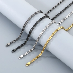 Detailed close-up of 18k oval buckle necklaces in silver, black, and gold finishes