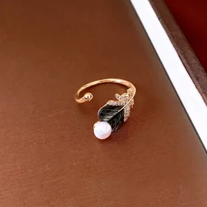 18k gold plated open ring featuring a pearl, green enamel leaf and sparkling crystal pavé
